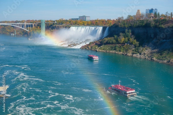 Fototapeta Niagara Falls. A pleasure boat with people near the huge famous waterfall. View from the Canadian side. Nature scenery. Photo for advertising, background, wallpaper, postcards.