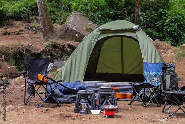 Obraz Camping Setup In Forest Clearing With Outdoor Adventure Equipment