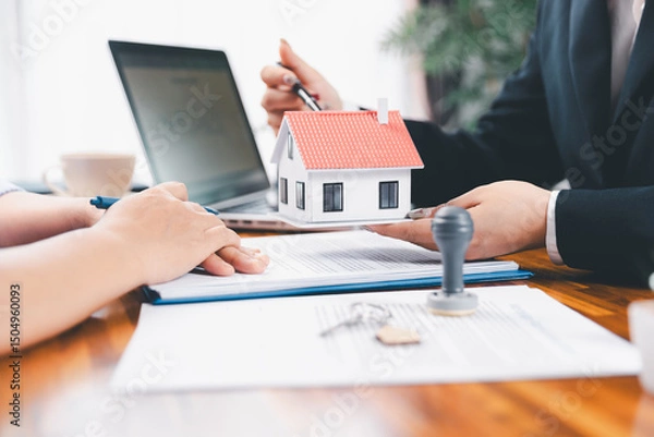 Obraz Bank approve loan to buy home concept. Real estate agent talked about terms of home purchase agreement, asked customer to sign documents to make contract legally. approved mortgage application form.