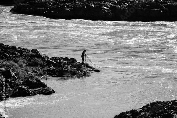 Obraz Black and white photo of a man fishing by the river in Iceland