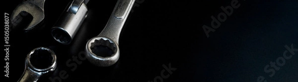 Fototapeta Tool set featuring chrome silver ring wrench, open end wrench, and block wrench arranged on dark background, photographed for automotive repair, industrial work, and mechanical gear content