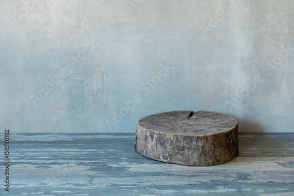 Fototapeta Atmospheric art background of plastered grey blue wall and empty shabby round wooden stand, copy space.
