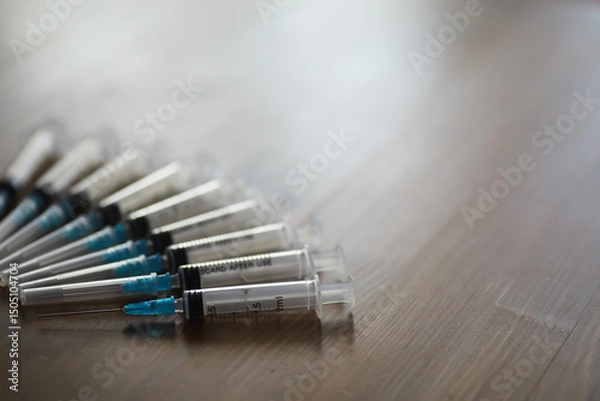 Obraz Row of Medical Syringes on Wooden Surface Highlighting Healthcare and Vaccination Concept