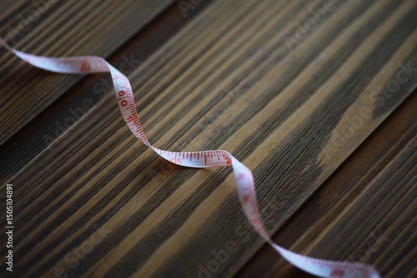 Obraz Flexible Measuring Tape on Wooden Surface - Precision, Craft, and Accuracy
