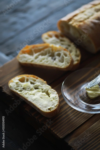 Obraz Close-Up of Artisan Bread Slices with Butter on Wooden Board
