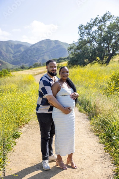 Obraz African American lovely outdoor setting, couple joyfully celebrates their pregnancy, capturing the essence of love and connection in this special moment filled with affection 