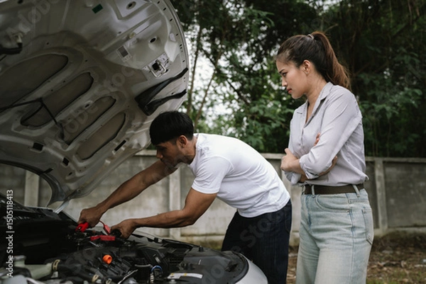 Fototapeta Man inspecting damaged car after crash, documenting insurance claim with mobile phone, showing frustration, analysis, and need for repair service.