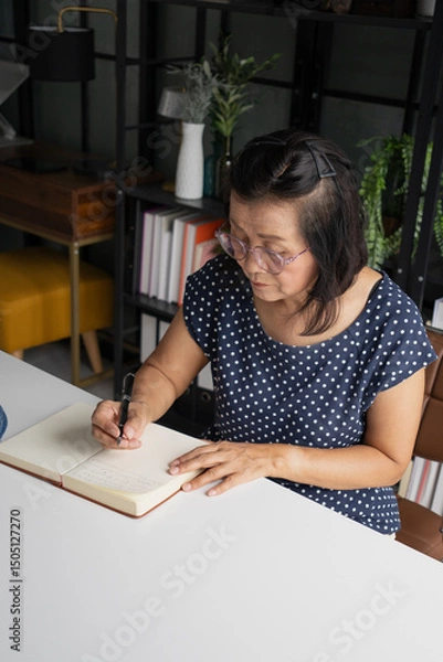 Fototapeta Senior Asian woman Write a diary in a notebook