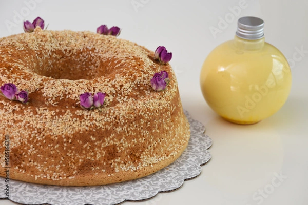 Fototapeta Elegant Lavender Bundt Cake with Glaze lightly dusted with powdered sugar and drizzled with a delicate white glaze and sesame seeds closeup side view of unique dessert