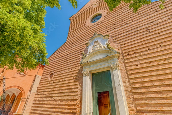Fototapeta close up of the Saint Christopher church, in Charterhouse in Ferrara city of Italy, with its terracotta bricks facade and bell tower in a sunny day is a beautiful example of Renaissance architecture.