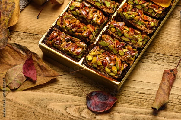 Obraz Sweet food Turkish delight on wooden background, assorted pistachio and candy for decorated backdrop