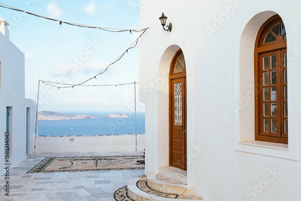 Fototapeta Traditional Mediterranean building with arched door and windows, overlooking the sea