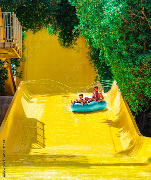Fototapeta Photo from Hurghada in Egypt of father with son on water slide