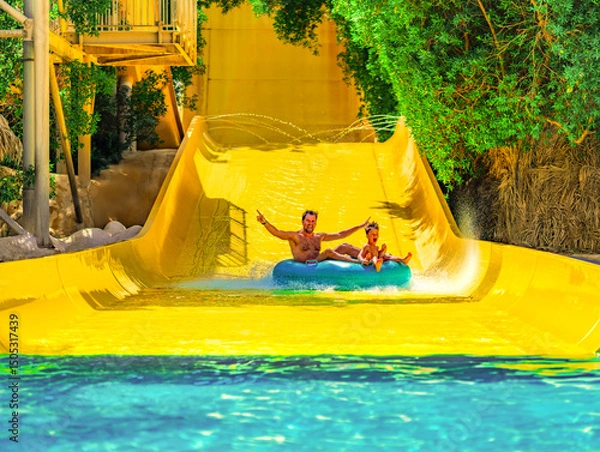 Fototapeta Photo from Hurghada in Egypt of father with son on water slide