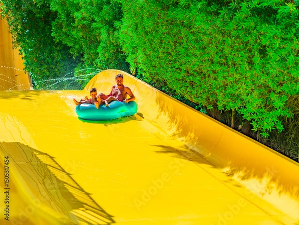 Fototapeta Photo from Hurghada in Egypt of father with son on water slide