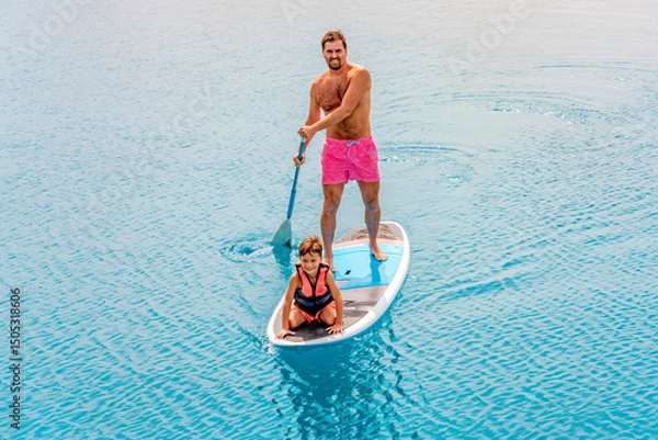 Fototapeta Photo from Hurghada in Egypt Father with sons on paddleboard
