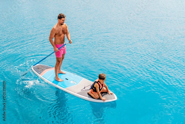 Fototapeta Photo from Hurghada in Egypt Father with sons on paddleboard