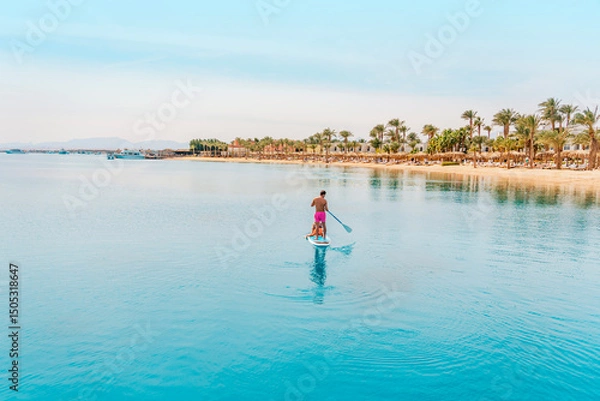 Fototapeta Photo from Hurghada in Egypt Father with sons on paddleboard