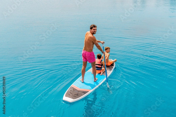 Fototapeta Photo from Hurghada in Egypt Father with sons on paddleboard
