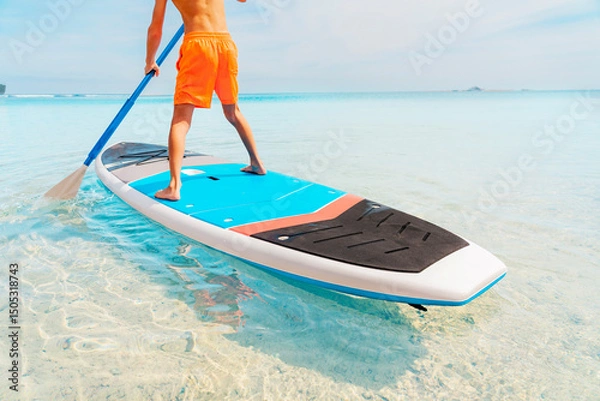 Fototapeta Photo from Hurghada in Egypt of boy on paddleboard