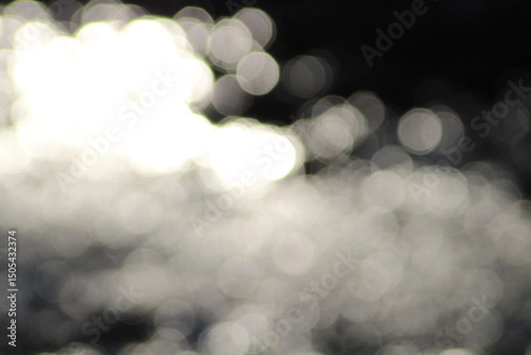 Obraz Beautiful shiny silver river background. Beautiful silver water bokeh background. Christmas lights in bokeh. Outside in December. Silver bokeh on a black background. bokeh abstract backdrop, Xmas
