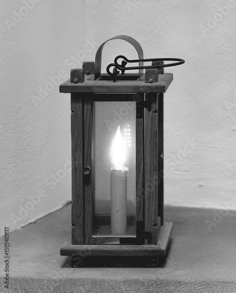 Obraz Warm light flickers softly from antique lantern illuminating the cozy corner of a rustic home at dusk in a quiet neighborhood