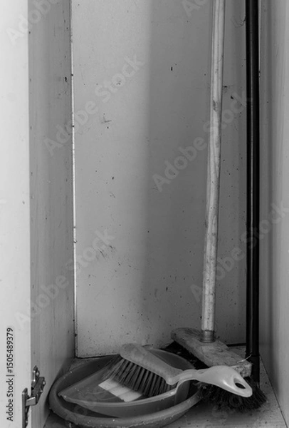 Obraz Cleaning tools neatly organized in a small cabinet showing signs of wear from daily use