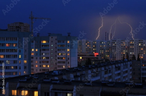 Obraz Lightning strike in the city. Storm outside. Thunderstorm with lightning in the city. Moment lightning