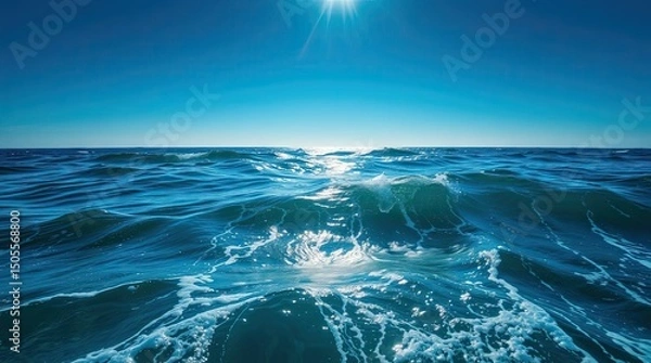 Fototapeta Stunning view of the deep blue ocean with waves and sunlight on a bright day