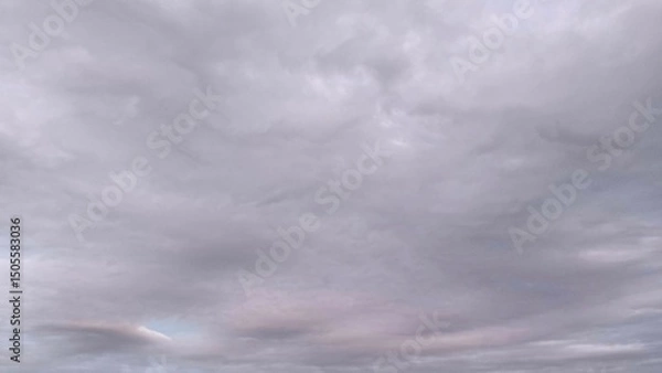 Fototapeta Subtle pastel gray sky with layered cloud textures, soft lighting and minimal tones ideal for backgrounds, mood boards, or atmospheric visual projects.