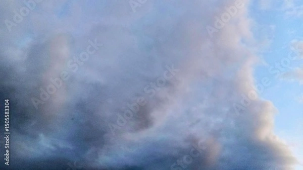 Fototapeta Overcast sky with thick gray clouds and soft blue tones, atmospheric and moody backdrop suitable for weather, nature, or cinematic backgrounds.