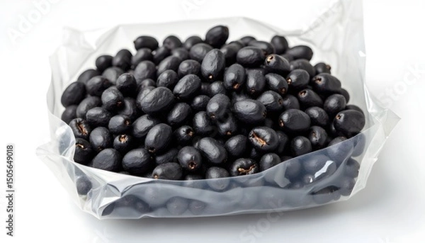 Fototapeta A clear plastic bag filled with small black fruits on a white surface