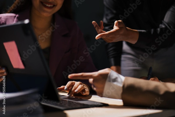 Fototapeta Close up of hand teamwork business group are meeting working overtime and brainstorming about business financial and marketing on paperwork and presentation.