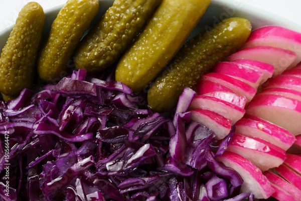 Fototapeta appetizer close-up - pickled cucumbers and red cabbage and radishes