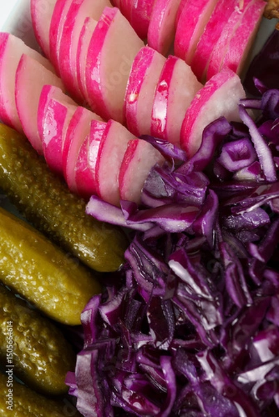 Fototapeta appetizer close-up - pickled cucumbers and red cabbage and radishes