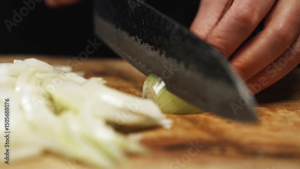 Obraz Female Chef Slicing Onion on Wooden Cutting Board.