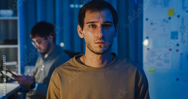 Fototapeta Team adult male freelance developer work late typing write prompt AI bot app program nomad terminal code at office night. Artificial intelligence dashboard, robotics, user interface, machine learning.