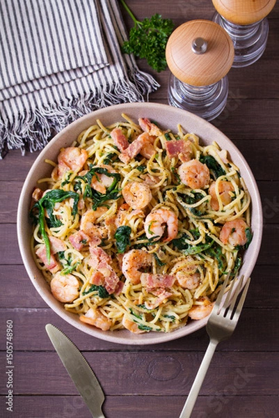 Fototapeta Prawn and bacon pasta with spinach. Spaghetti. View from above, top view