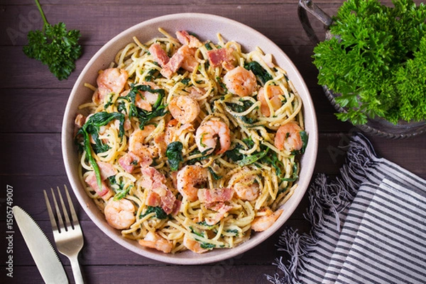 Fototapeta Prawn and bacon pasta with spinach. Spaghetti. View from above, top view