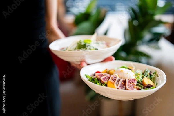 Fototapeta Two bowls of fresh, vibrant salads—one with seared tuna, mixed greens, and a poached egg, the other with assorted vegetables. Natural light enhances the appetizing presentation.