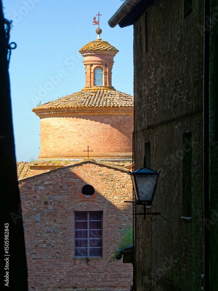 Obraz Dome of Sant Ansano Church in Piazzetta della Selva. The curved structure, with a classic lantern, stands against the clear blue sky. Travel to Siena, Tuscany, Italy.