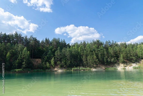 Obraz Beautiful summer landscape - a lake surrounded by green trees against a blue sky