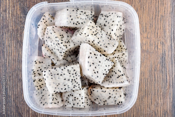 Obraz Sliced pieces of fresh pitahaya pulp in a plastic container.