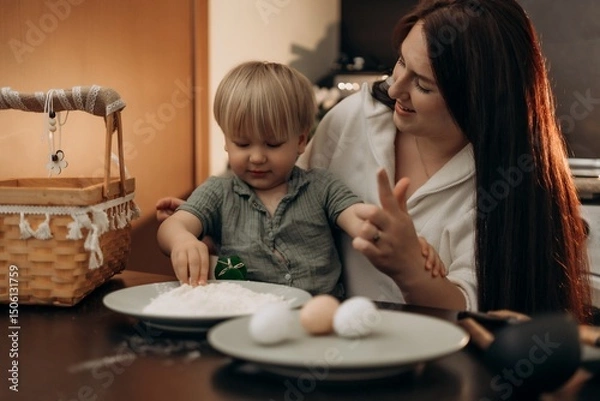 Fototapeta Easter kitchen fun with mom and toddler creating holiday crafts through messy play gentle parenting and mindful bonding making sweet spring memories with flour eggs and lots of laughter together