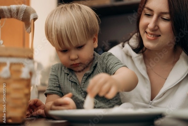 Fototapeta Joyful bonding in the kitchen as a toddler learns through playful flour exploration guided by a loving mother creating memories of creativity growth connection and mindful parenting through fun