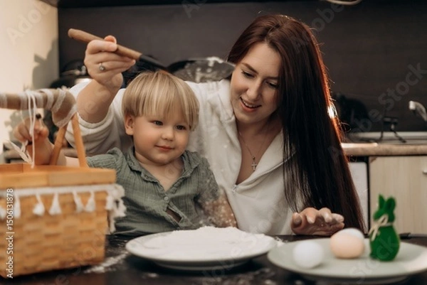 Fototapeta Creative parenting meets indoor Easter fun as toddler explores flour with sensory play joyful learning and family traditions in a cozy kitchen moment of bonding mess and heartwarming spring connection