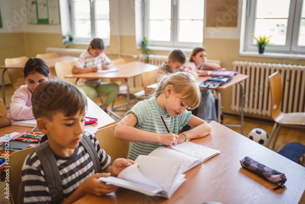 Obraz school girl and boy pupils attend class in the classroom