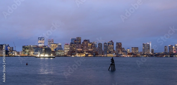 Fototapeta Boston skyline at dusk, with water and a marker in the foreground.