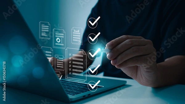 Obraz A person working on a laptop with graphics of documents and checklist icons appearing above the keyboard, representing online document management, data verification in the modern technology era.
