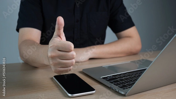 Obraz Businessman hand showing finger gesture thumb up sign, recommendation or good job choice. Professional multicultural team recommend corporate service.